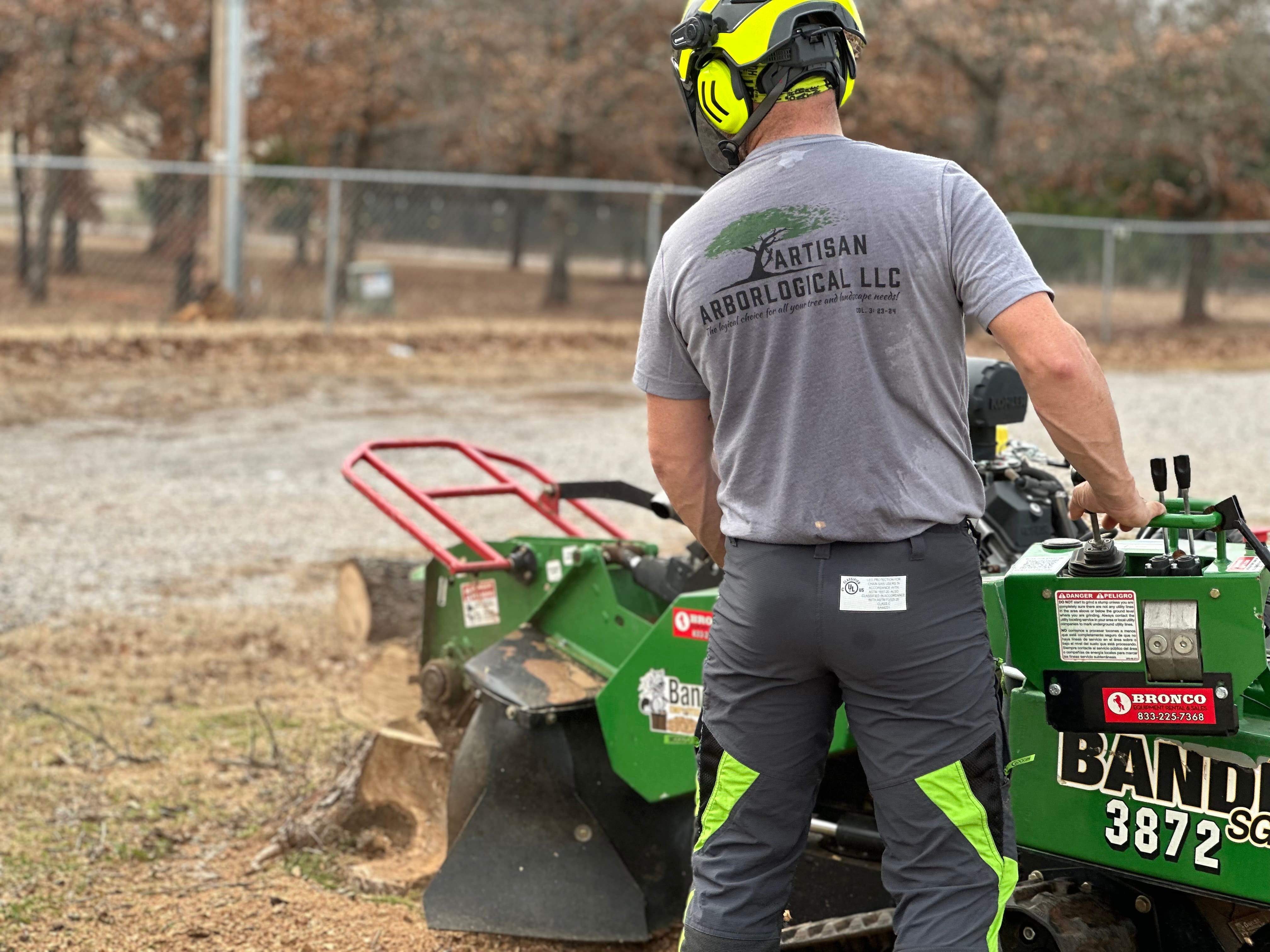 Artisan ArborLogical team operating professional stump grinding equipment